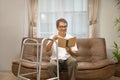 Sarcopenia older man is reading a book for relax at nursinghome . Sarcopenia is a degenerative disease of the muscle usually