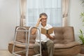Sarcopenia older man is reading a book for relax at nursinghome . Sarcopenia is a degenerative disease of the muscle usually