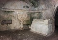 Sarcophagus and bas-relief of Menorah on the wall in the inner room of the necropolis in the Bet She`arim National Park. Kiriyat T