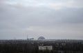 Sarcophagus (new shelter) of reactor 4 nuclear power plant and Pripyat ghost town at Chernobyl Exclusion Zone Royalty Free Stock Photo