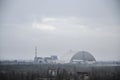 Sarcophagus (new shelter) of reactor 4 nuclear power plant and Pripyat ghost town at Chernobyl Exclusion Zone Royalty Free Stock Photo