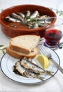 Sardines baked in a terracotta bowl Royalty Free Stock Photo