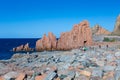 Sardinia Coastline: Typical Red Rocks and Cliffs and Tourists near Sea in Arbatax; Italy Royalty Free Stock Photo