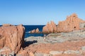 Sardinia Coastline: Typical Red Rocks and Cliffs and Tourists near Sea in Arbatax; Italy Royalty Free Stock Photo