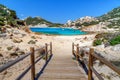 Sardinia, holidays, beautiful beaches of the archipelago of La Maddalena, a wooden bridge leading to the beach. Royalty Free Stock Photo