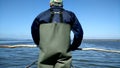 Sardinia. People. A fisherman goes to the fishing grounds in a coastal pond