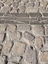 Sardinia. Traditional architecture. Urban road paved with rough ashlars and polished slabs of local volcanic stones. Detail
