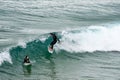 Sarges, Portugal - January 22, 2020: Surfers catch large waves at the beach at Praia do Beliche in the Algarve region of Portugal