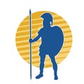 Silhouette of a roman soldier wearing armor suit in pose with spear weapon and metal shield. Royalty Free Stock Photo