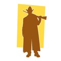 Silhouette of a cowboy or hunter in pose with his long barreled gun firearm.