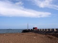 A red car inappropriately parked at the end of a fishing pier Royalty Free Stock Photo