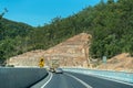 Vehicles Descending A Mountain Highway With Artificial Barricades