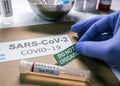 SarsCov2 coronavirus pcr vial together with a dossier folder indicating not to be discarded Royalty Free Stock Photo