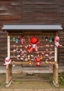 Sarubobo dolls on a rack at Hikakokubun-ji Buddhist Temple.