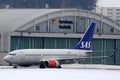 SAS Scandinavian Airlines plane taxiing in Innsbruck Airport INN, snow