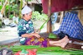 Sasak woman make basket from leaf of banana