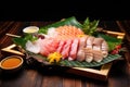 sashimi platter with thin raw fish slices on bamboo leaves
