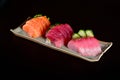 Sashimi slices mix isolated on dark background