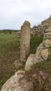 Sassari, Sardinia in Italy, May 18 2023. A menhir in front of the sacred altar of Monte d'Accoddi.