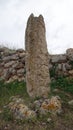 Sassari, Sardinia in Italy, May 18 2023. A menhir in front of the sacred altar of Monte d'Accoddi.