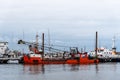 Red dredge ship moored in the harbour of Sassnitz in Rugen Island Royalty Free Stock Photo