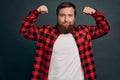 Sassy confident smiling macho man with big muscles, proudly pointing his hand as showing biceps on arm, pointing at hand and smirk Royalty Free Stock Photo
