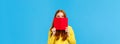 Sassy and creative happy charismatic redhead woman, teenager hiding face behind red notebook and smiling, grinning sly