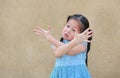 Sassy little Asian kid girl with funny face and expression cross one`s arm Royalty Free Stock Photo