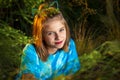 Sassy Looking Girl Smirking at the Camera Behind Tree Branches Royalty Free Stock Photo