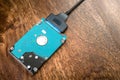Sata cable connected to hdd 2.5 hard drive disk on wooden table closeup view Royalty Free Stock Photo
