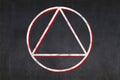 Satanist triangle within a circle symbol drawn on a blackboard