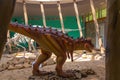 SATAPLIA, KUTAISI, GEORGIA: A statue of a moving dinosaur and a skeleton in the museum in the reserve in Sataplia. Royalty Free Stock Photo