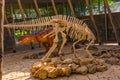 SATAPLIA, KUTAISI, GEORGIA: A statue of a moving dinosaur and a skeleton in the museum in the reserve in Sataplia. Royalty Free Stock Photo