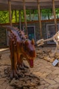 SATAPLIA, KUTAISI, GEORGIA: A statue of a moving dinosaur and a skeleton in the museum in the reserve in Sataplia. Royalty Free Stock Photo