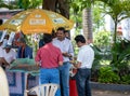 A group of Indian men eating fruit salad at a small stall