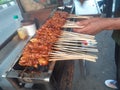 Satay seller grilling satay on a burning coal grill Royalty Free Stock Photo