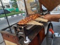 Satay seller grilling satay on a burning coal grill Royalty Free Stock Photo