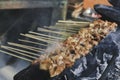 Sate Kambing or goat satay on red fire grilling by people
