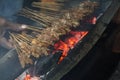 Satay goat or meat goat satay with charcoal ingredient on red fire grilling by people.per