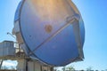 Satelite dish with sun flare on metal top with blue sky background in science center or laboratory Royalty Free Stock Photo