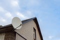 The satellite antenna installed on a house facade Royalty Free Stock Photo
