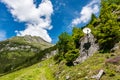 Satellite antenna mounted on a rock, around the green mountains. Beautiful summer mountain landscape - blue sky with white clouds Royalty Free Stock Photo