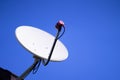 Satellite dish antenna on roof with blue sky background Royalty Free Stock Photo