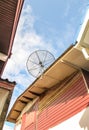 Satellite dish antenna for television on house roof Royalty Free Stock Photo