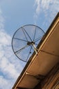 Satellite dish antenna for television on house roof Royalty Free Stock Photo