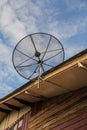 Satellite dish antenna for television on house roof Royalty Free Stock Photo