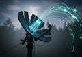 A satellite dish appears in a moody, forested background, emitting glowing blue digital streams and Royalty Free Stock Photo