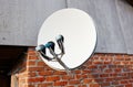 Satellite dish is attached to the wall of the house Royalty Free Stock Photo