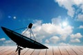 Satellite dish on blue sky and Wooden terrace background