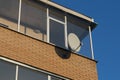 Satellite dish on the facade of a brick building. Royalty Free Stock Photo